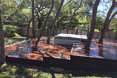 Built with dassoXTR, a hardwood decking product made of fused bamboo, the deck cascades down to a stone patio with fire pit. Less expensive than some tropical hardwoods, dassoXTR is 100% sustainable and will last for decades.